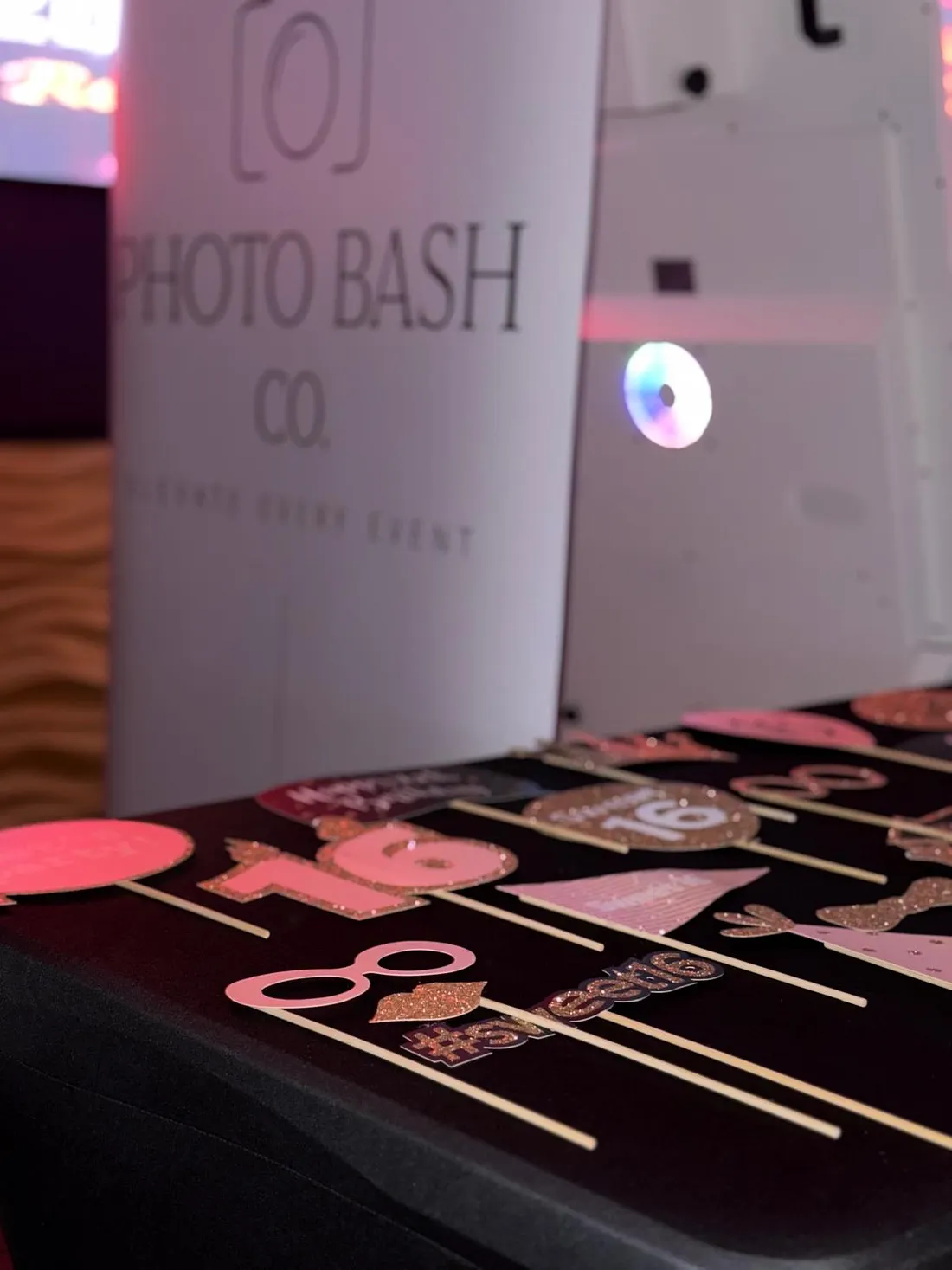 Custom PhotoBash props arranged beside the mirror booth at an event